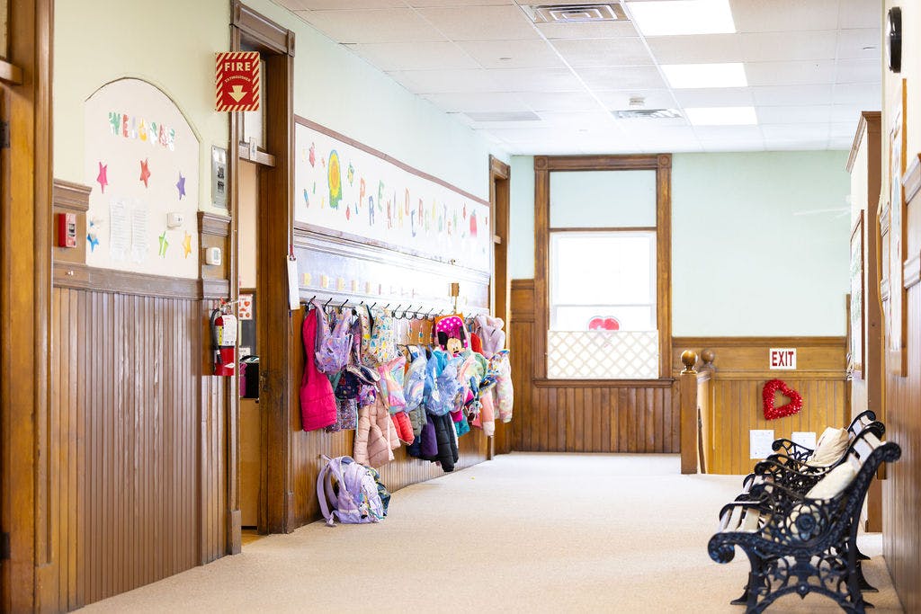 Hallway with coats and backpacks hanging on hooks