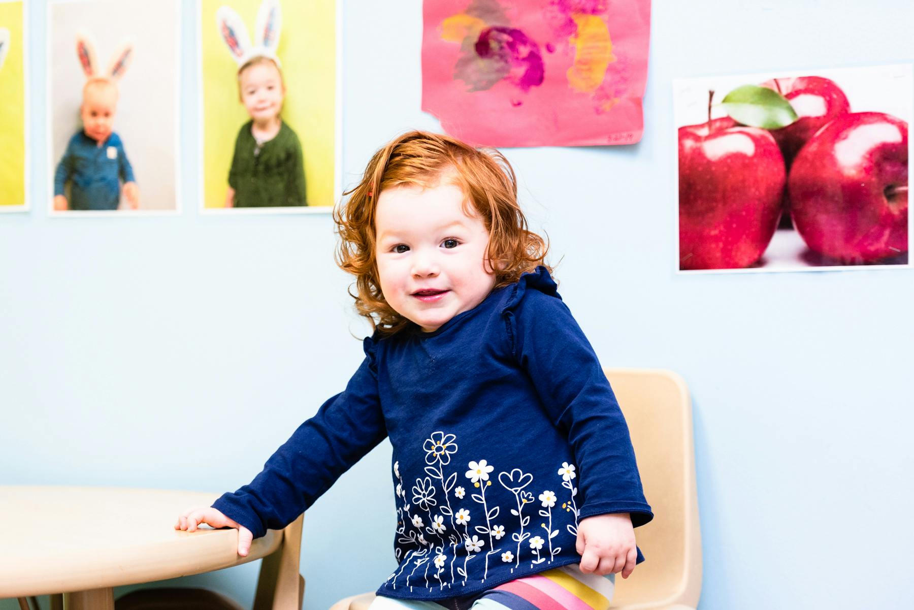 Child sitting at a table in a classroom