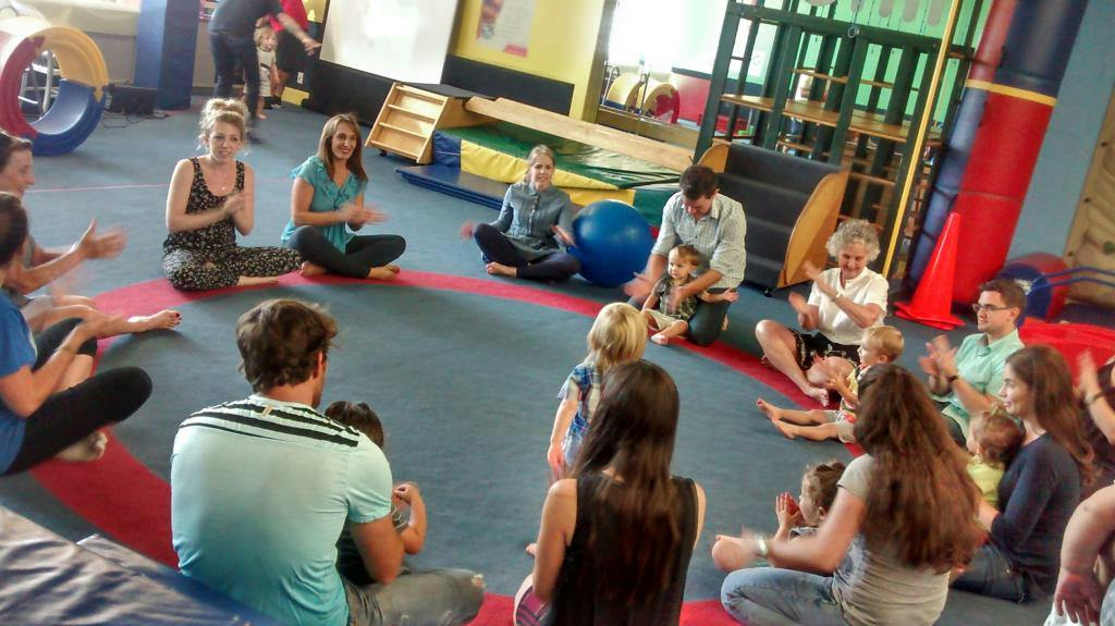 People and children sitting in a circle on the floor