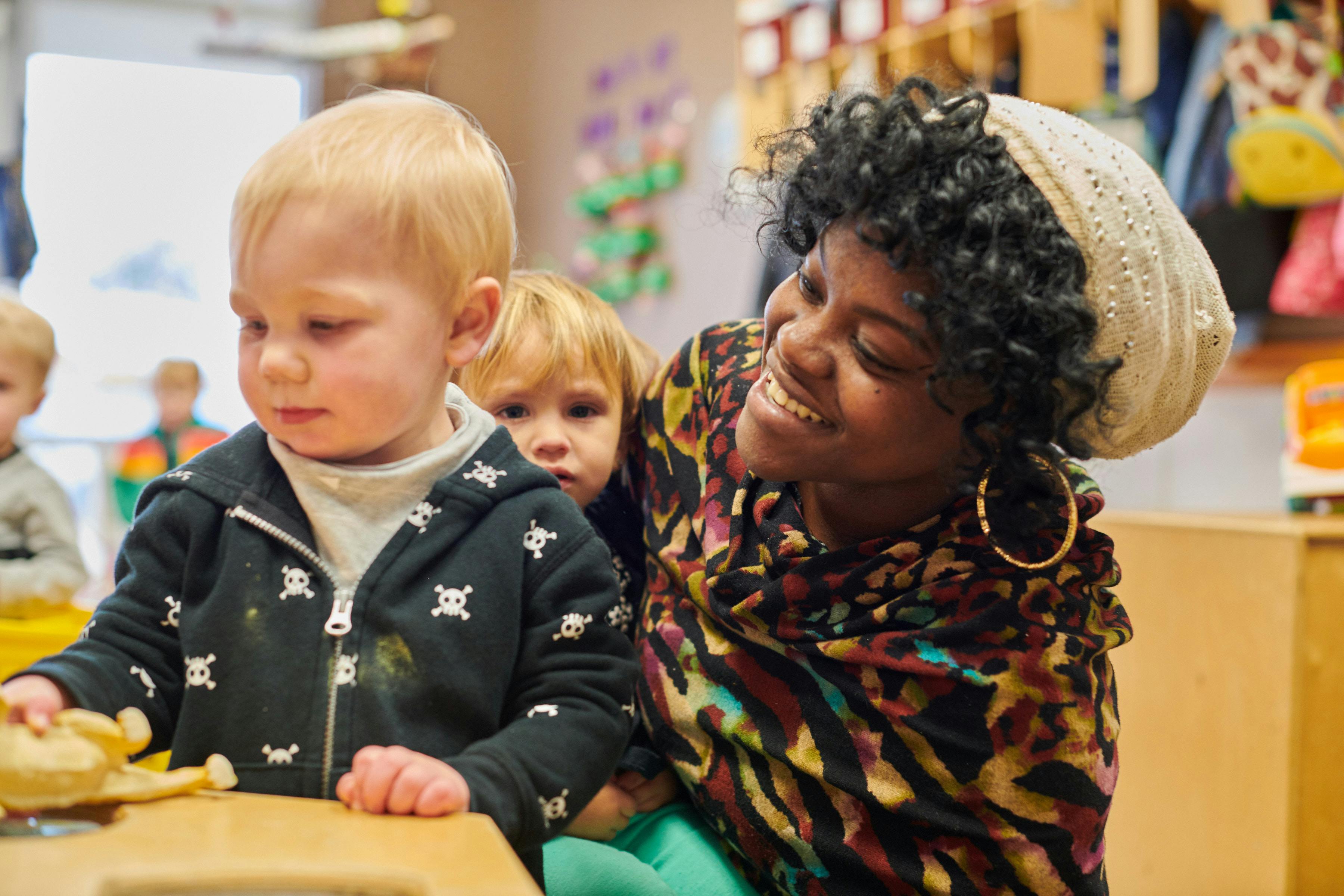 Adult and two children in a classroom