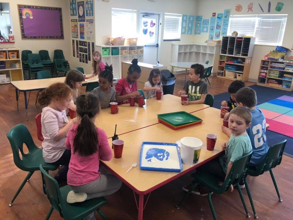 Children sitting around a table in a classroom
