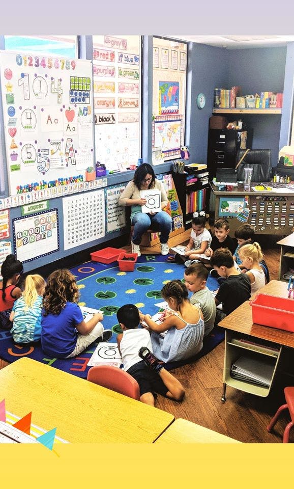 Person teaching children in a classroom