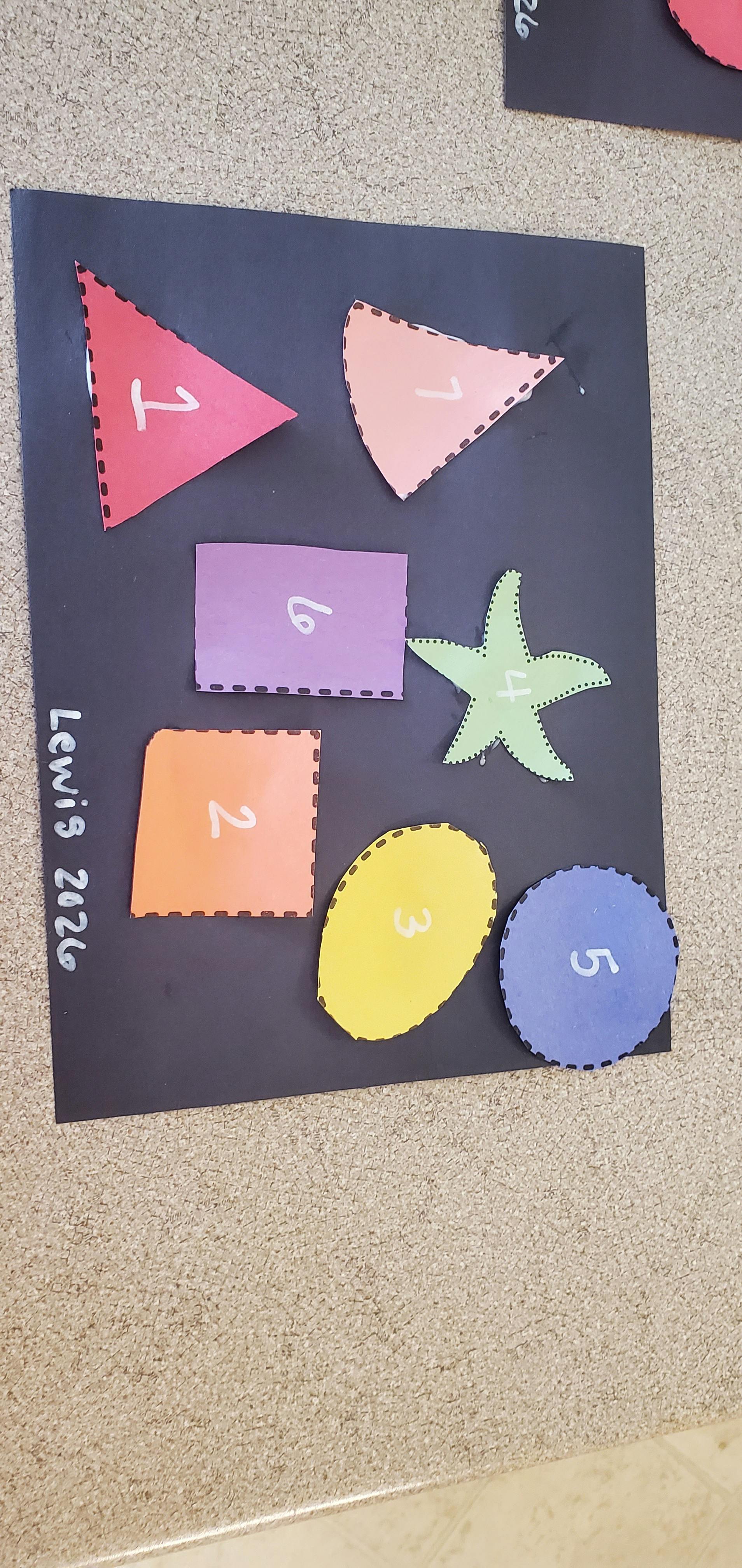 Colorful cut-out shapes with numbers on a black background