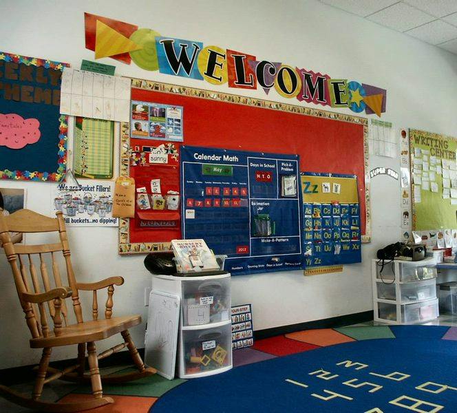 Classroom with a "WELCOME" sign, calendar, and rocking chair