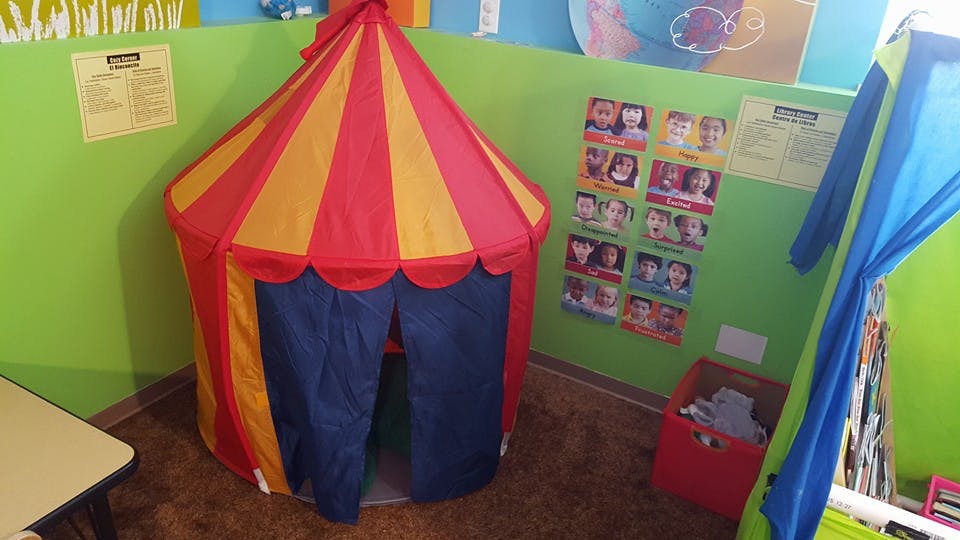 Red and yellow striped play tent in a room
