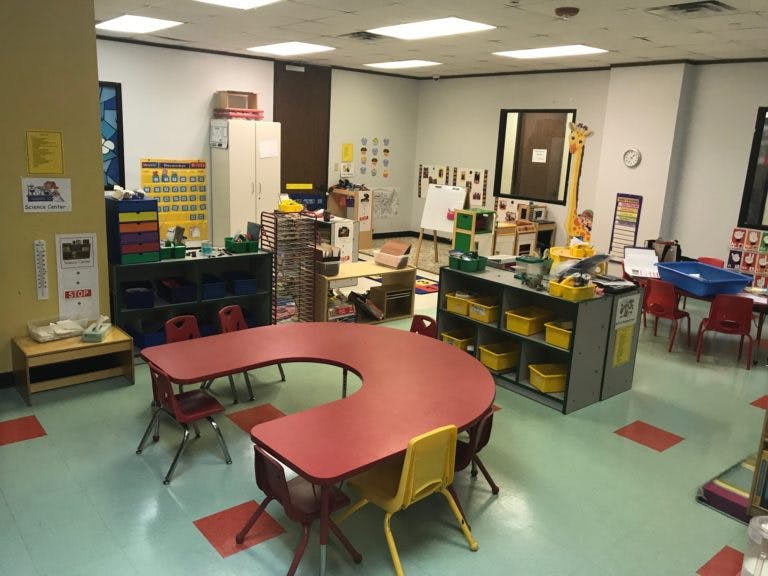 Classroom with a red U-shaped table and small chairs
