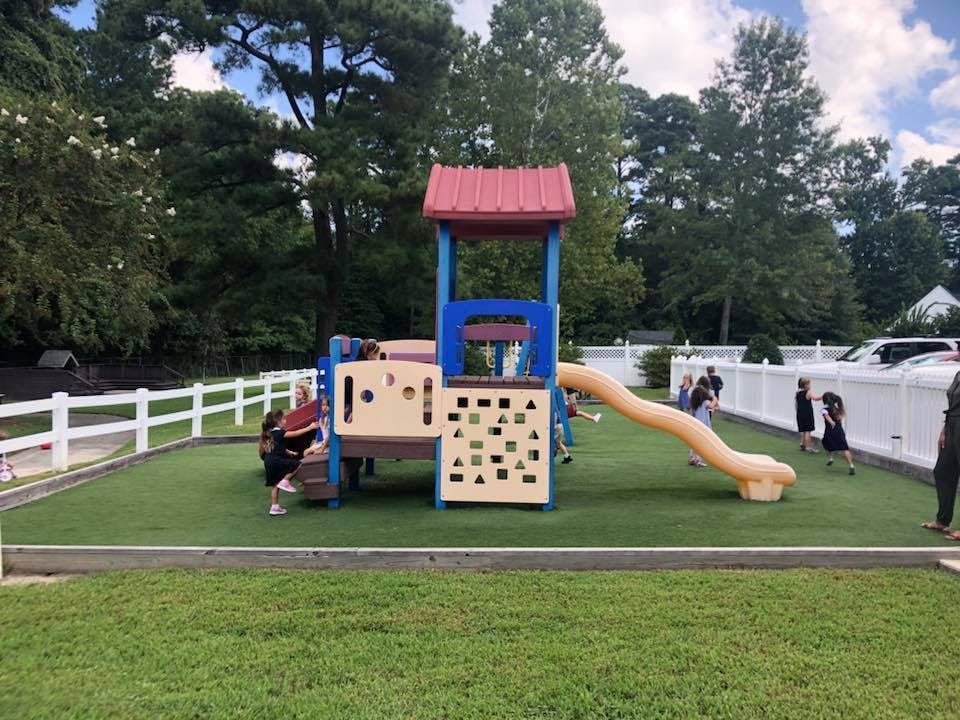 Children playing on a playground structure with a slide