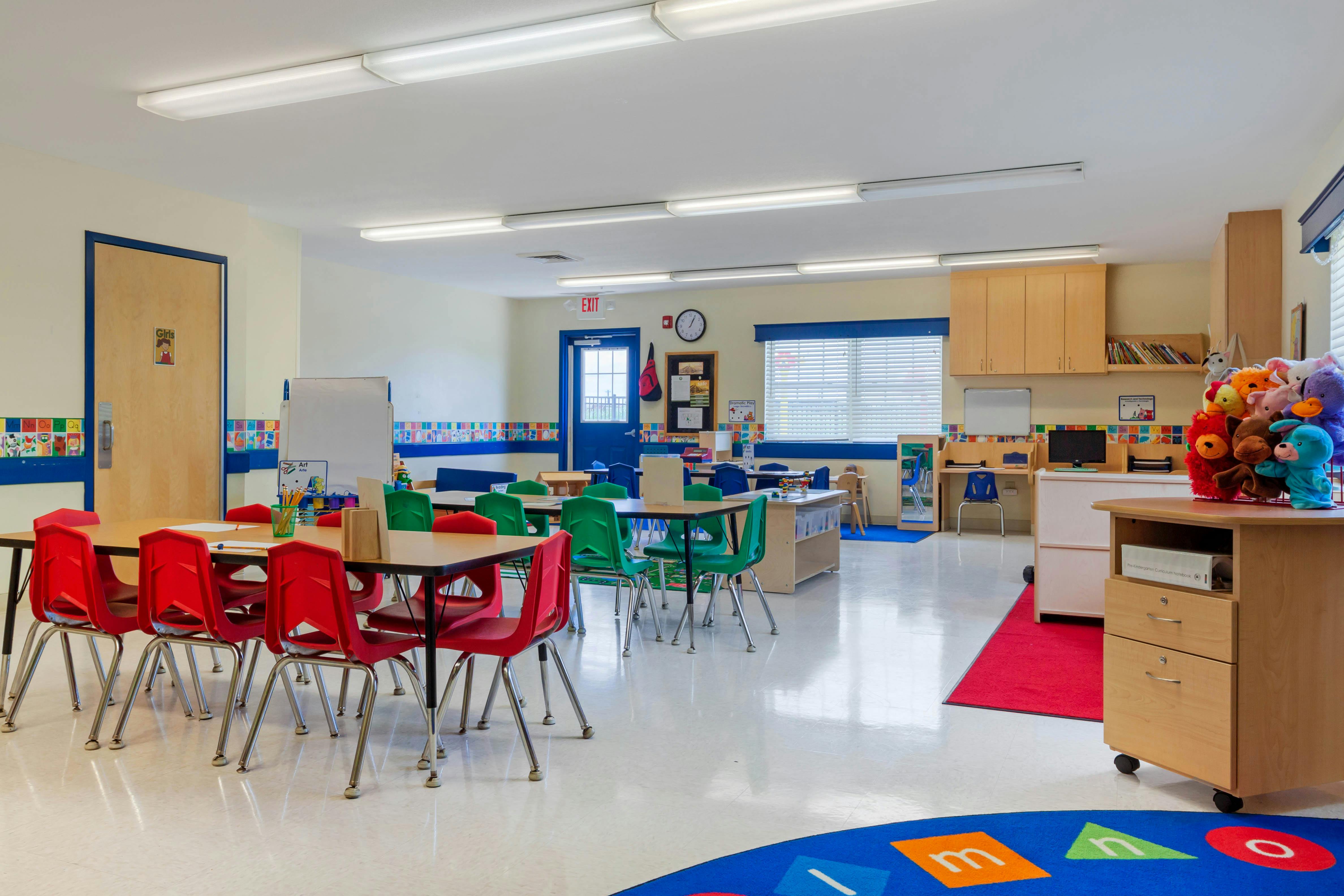 Classroom with small tables and chairs for children, colorful alphabet decor