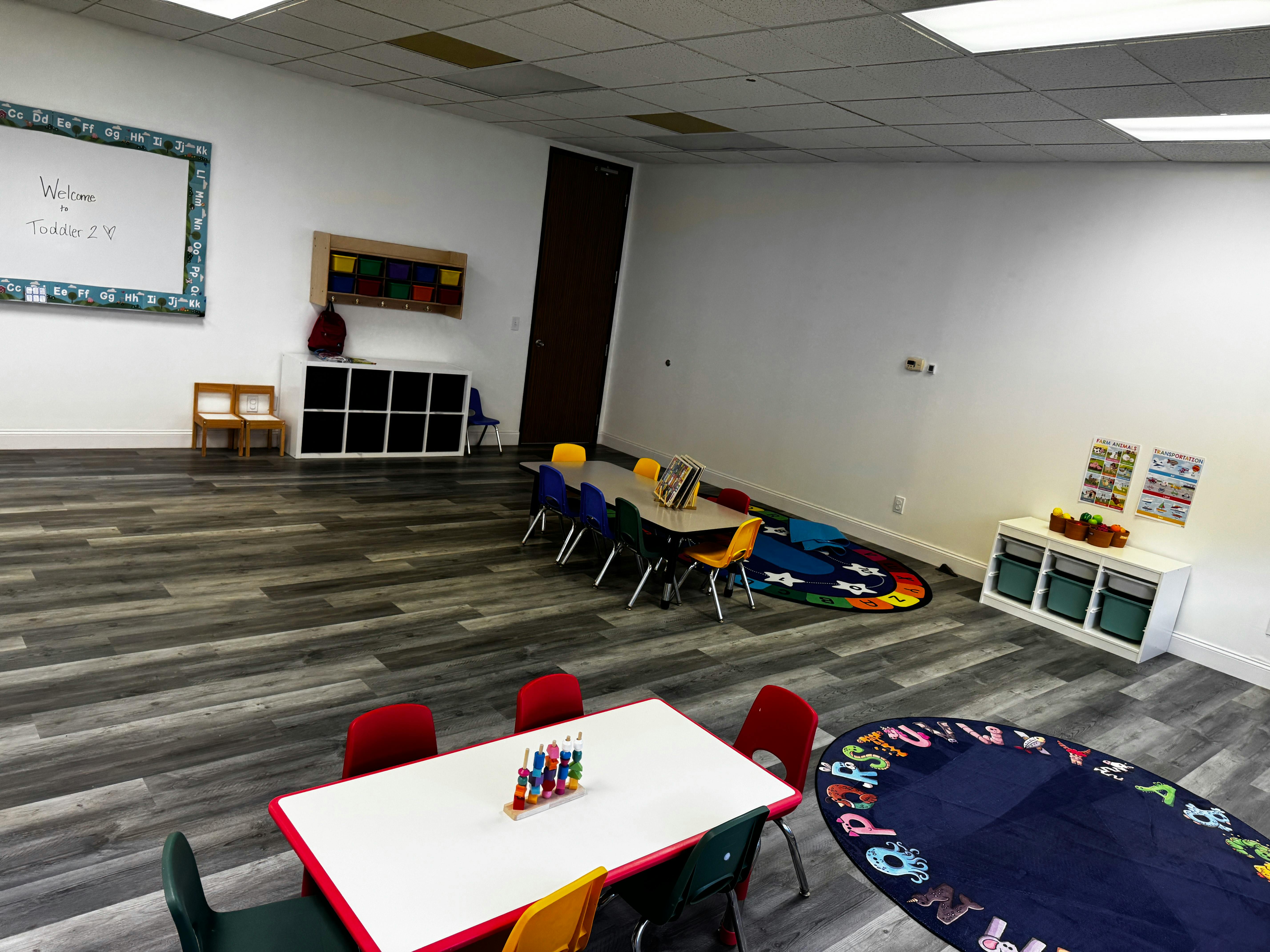 Empty classroom with small tables and chairs