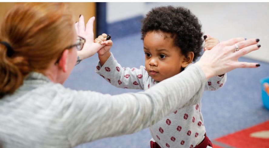 Adult and child reaching out to each other
