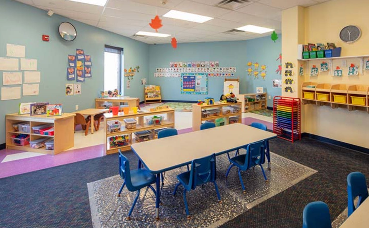 Empty classroom with small tables and chairs