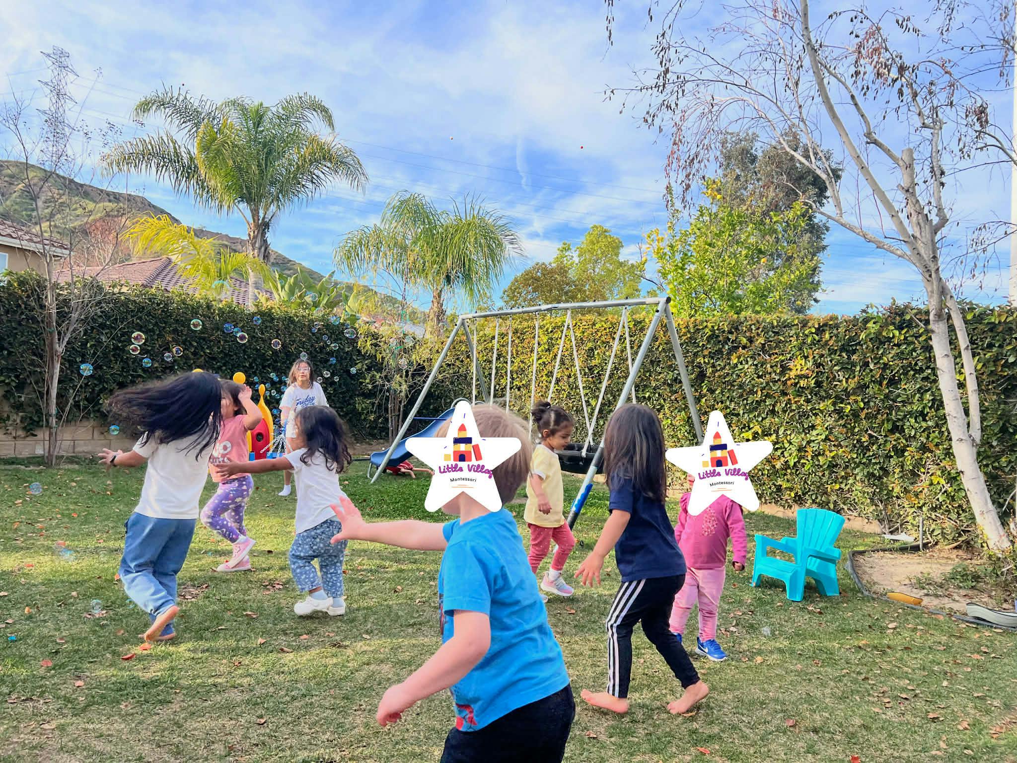 Group of children playing with bubbles in a park