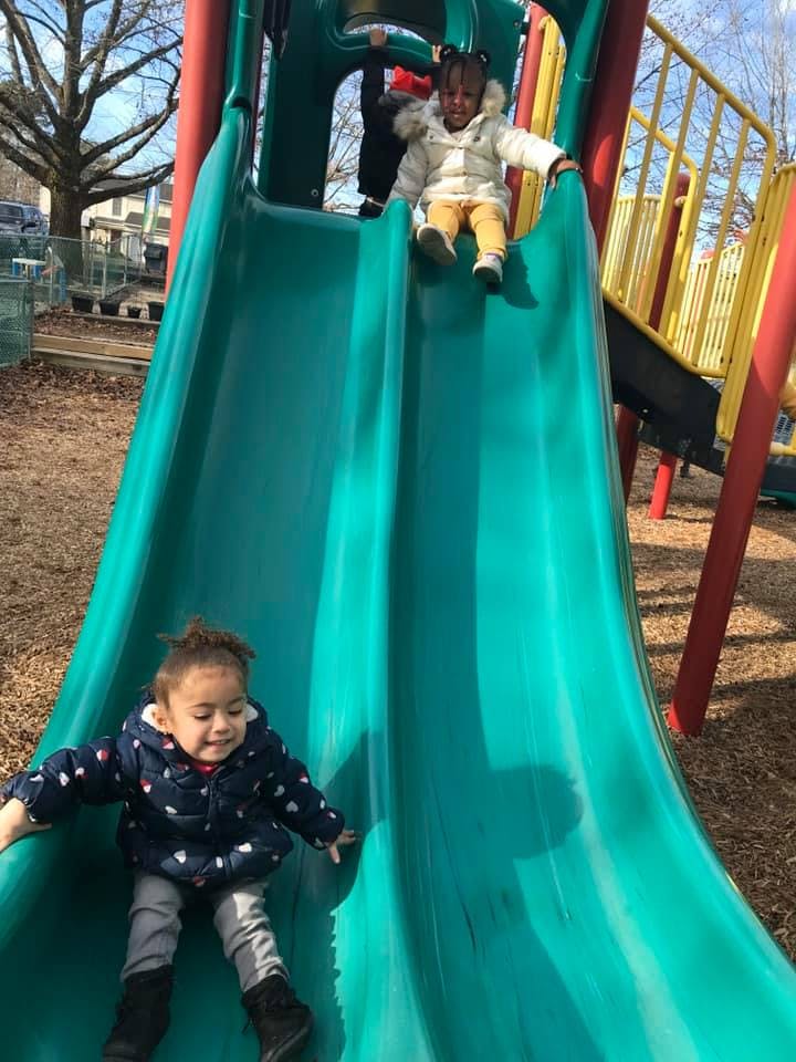 Two children on a playground slide