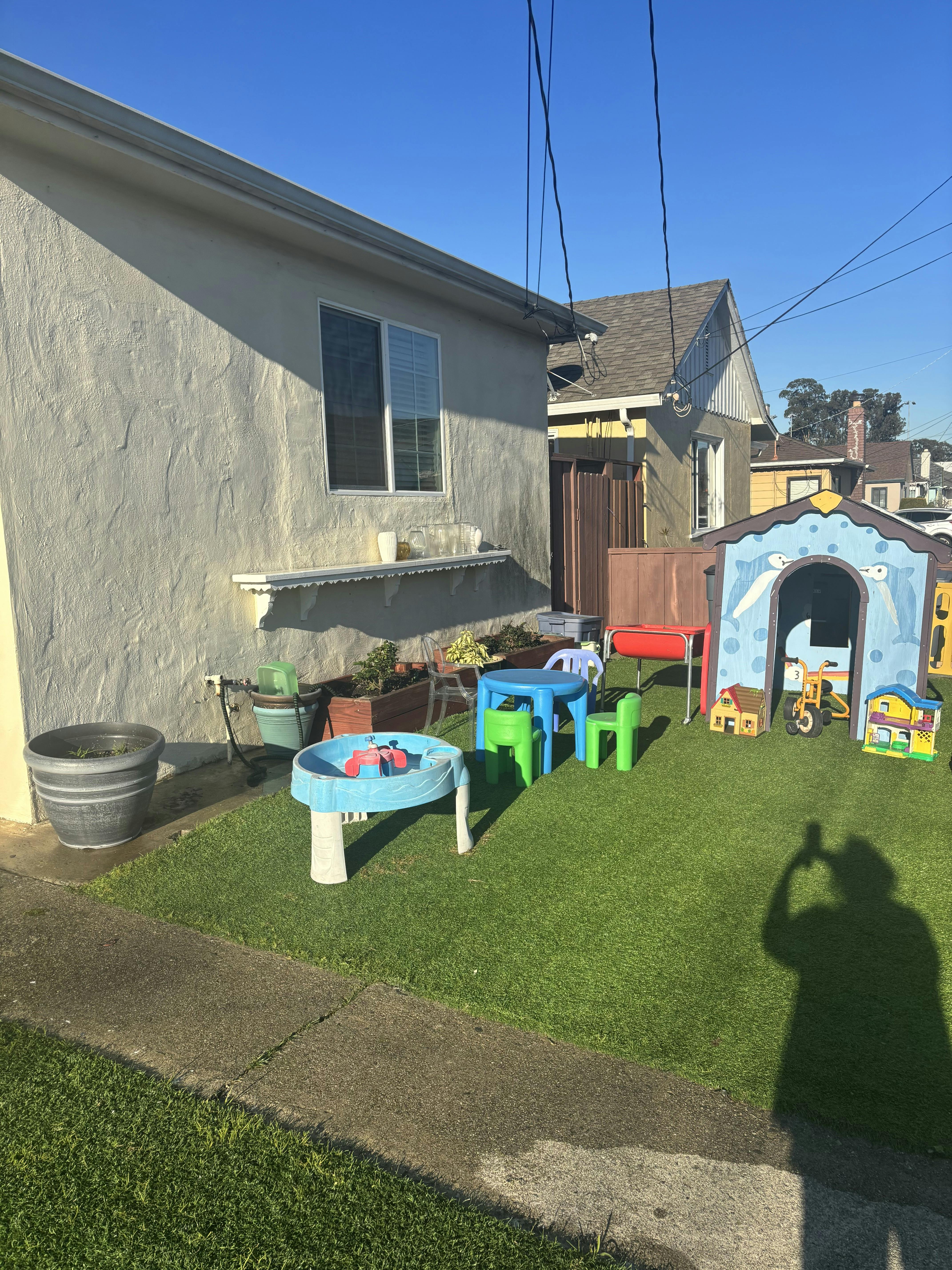 Backyard with artificial turf and children's play equipment