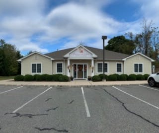 Single-story building with a parking lot in front