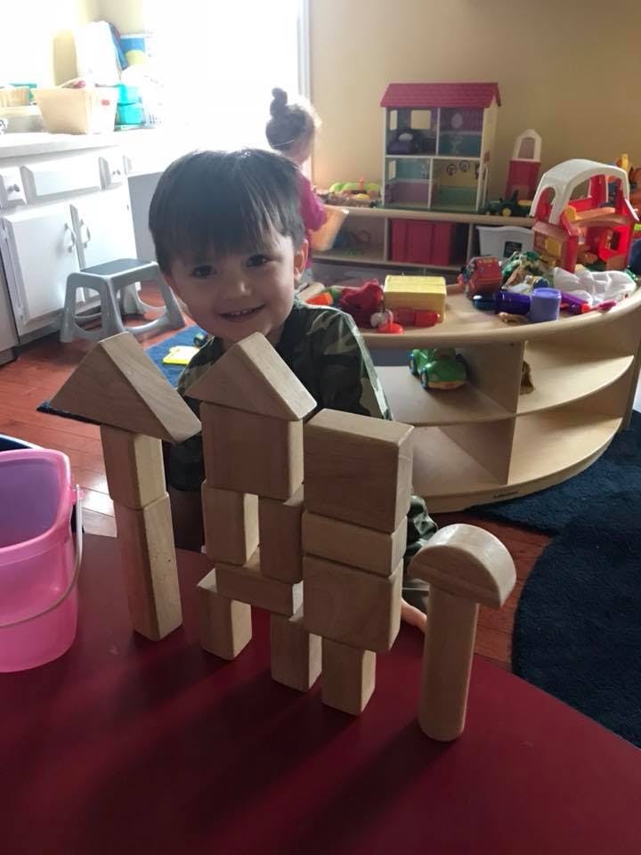Child playing with wooden blocks