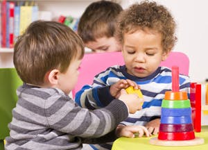 Two children playing with stacking toys