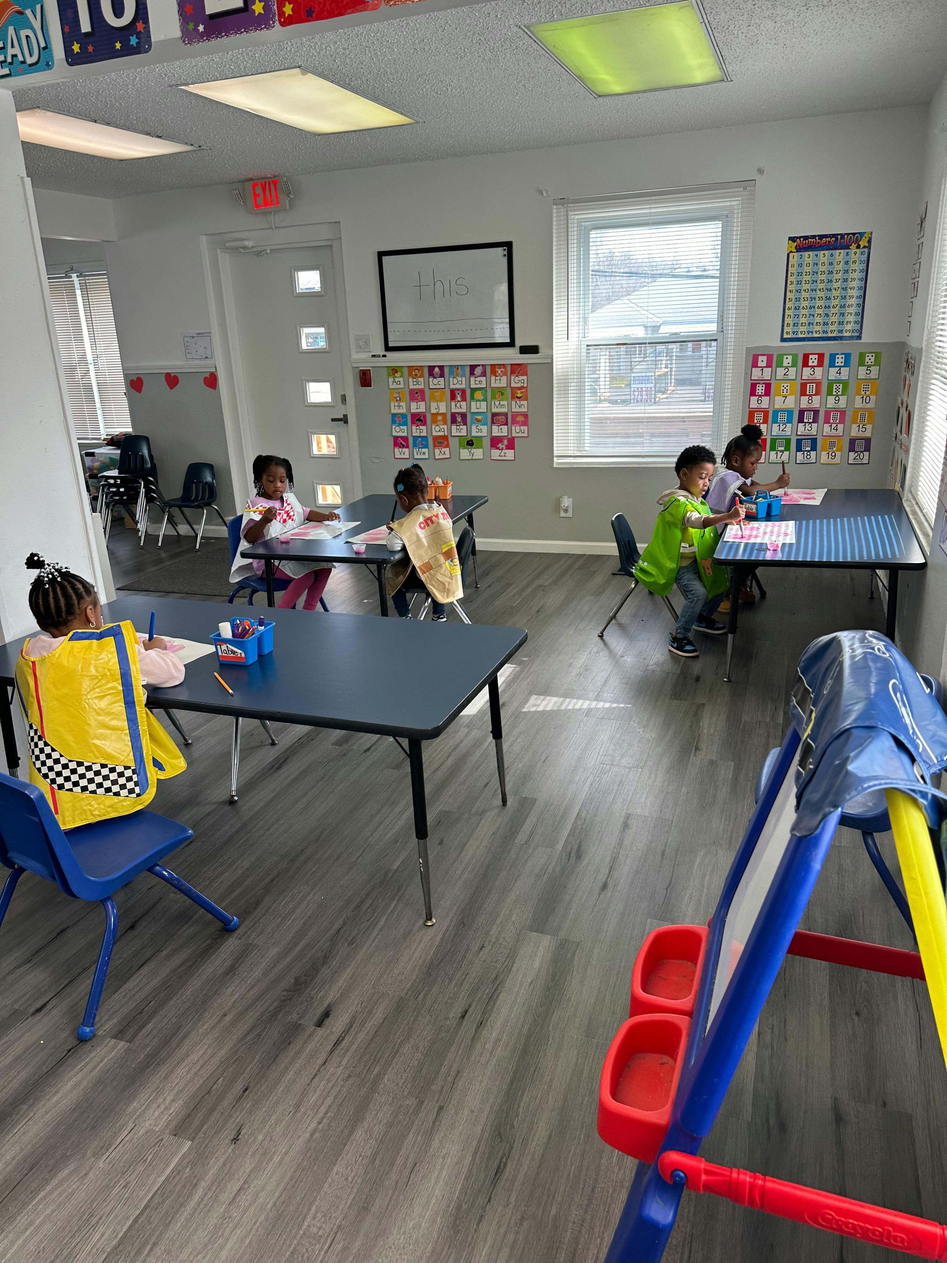 Children sitting at tables in a classroom