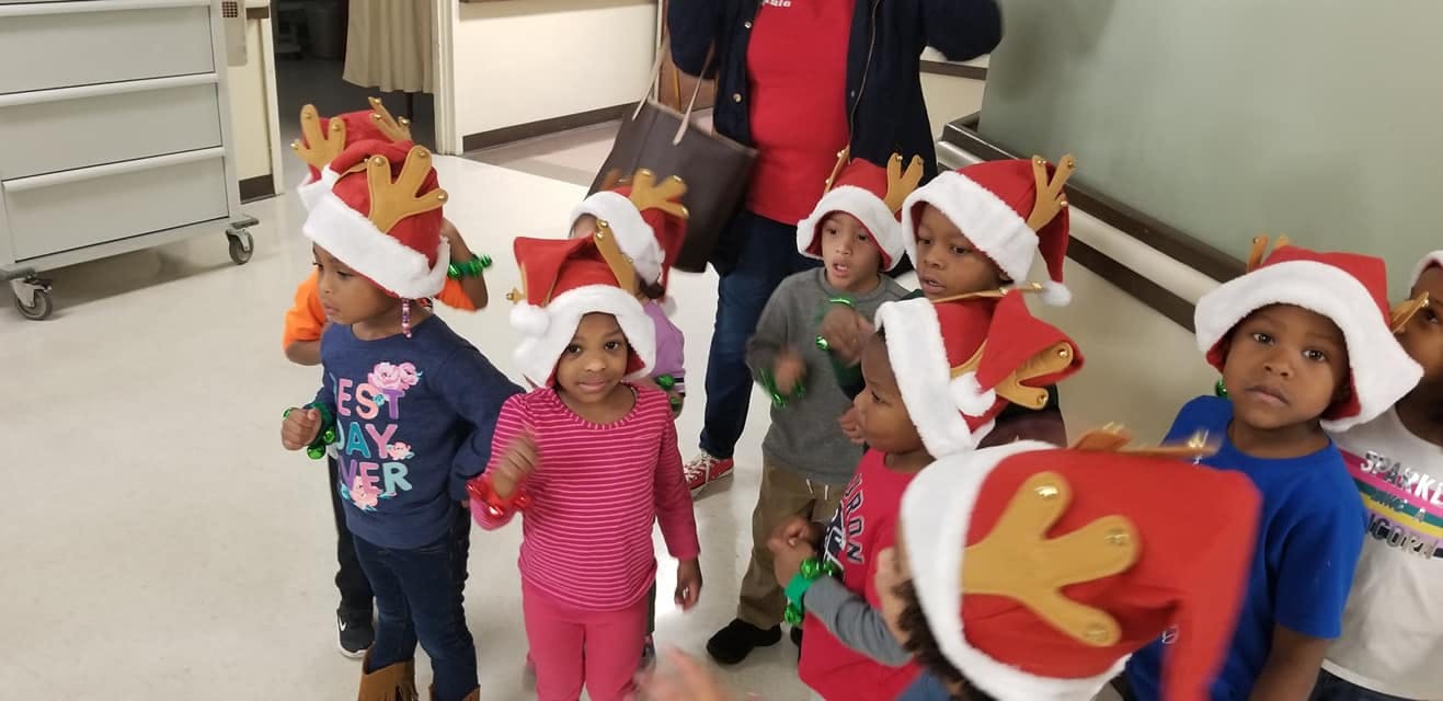 Group of children wearing Santa hats and reindeer headbands
