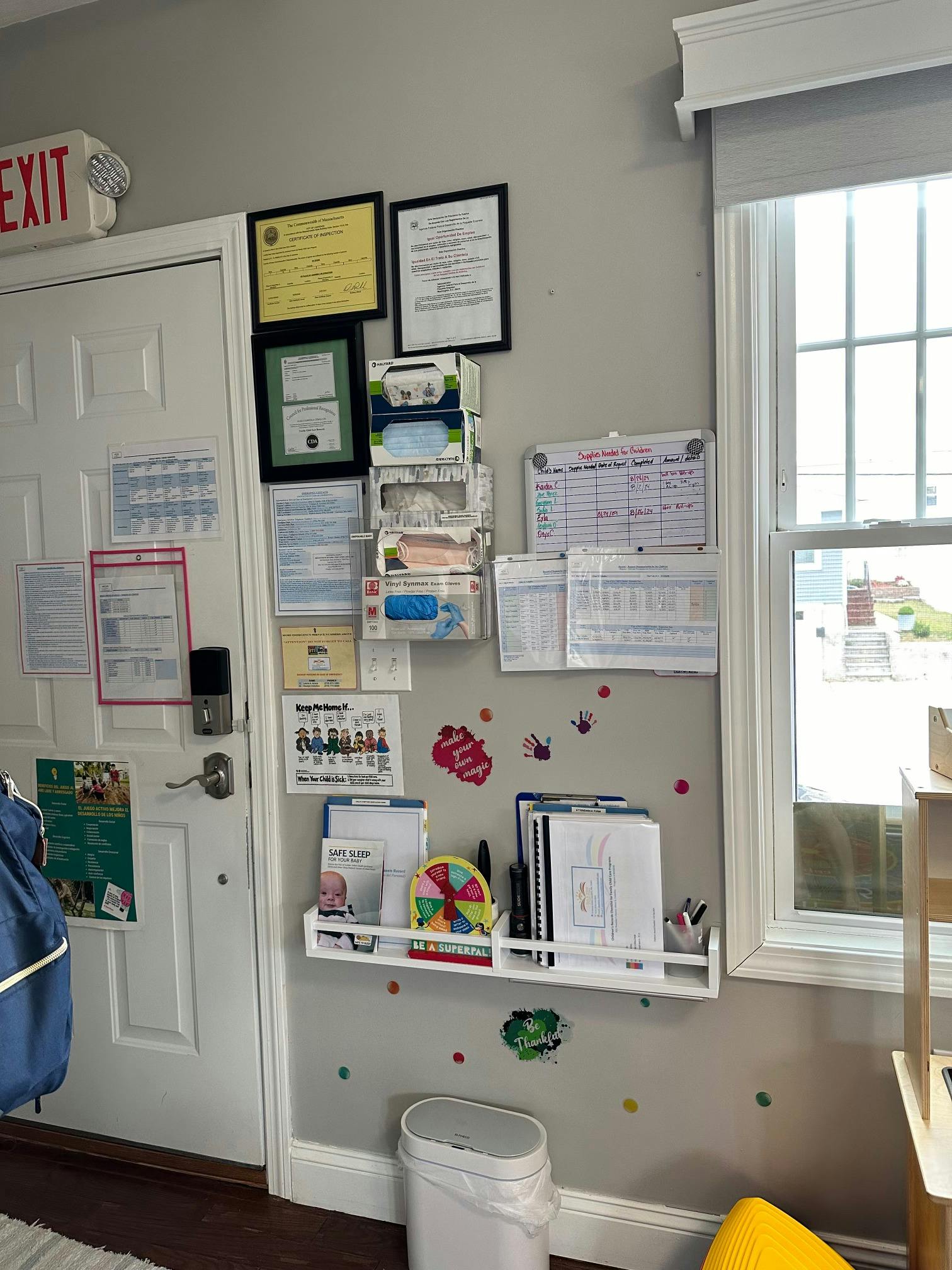 Informational wall in a child care setting with documents and supply charts