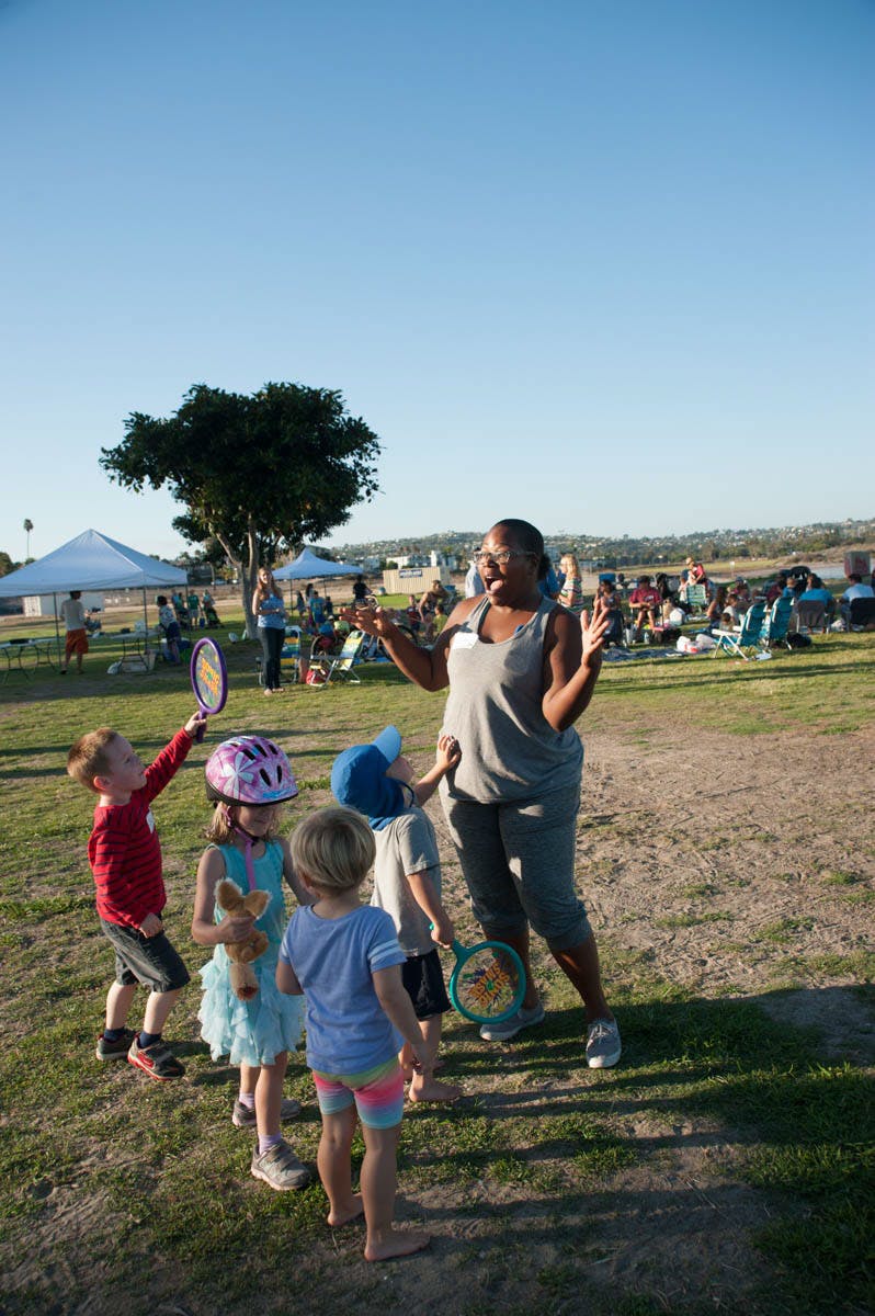 Adult person interacting with children outdoors