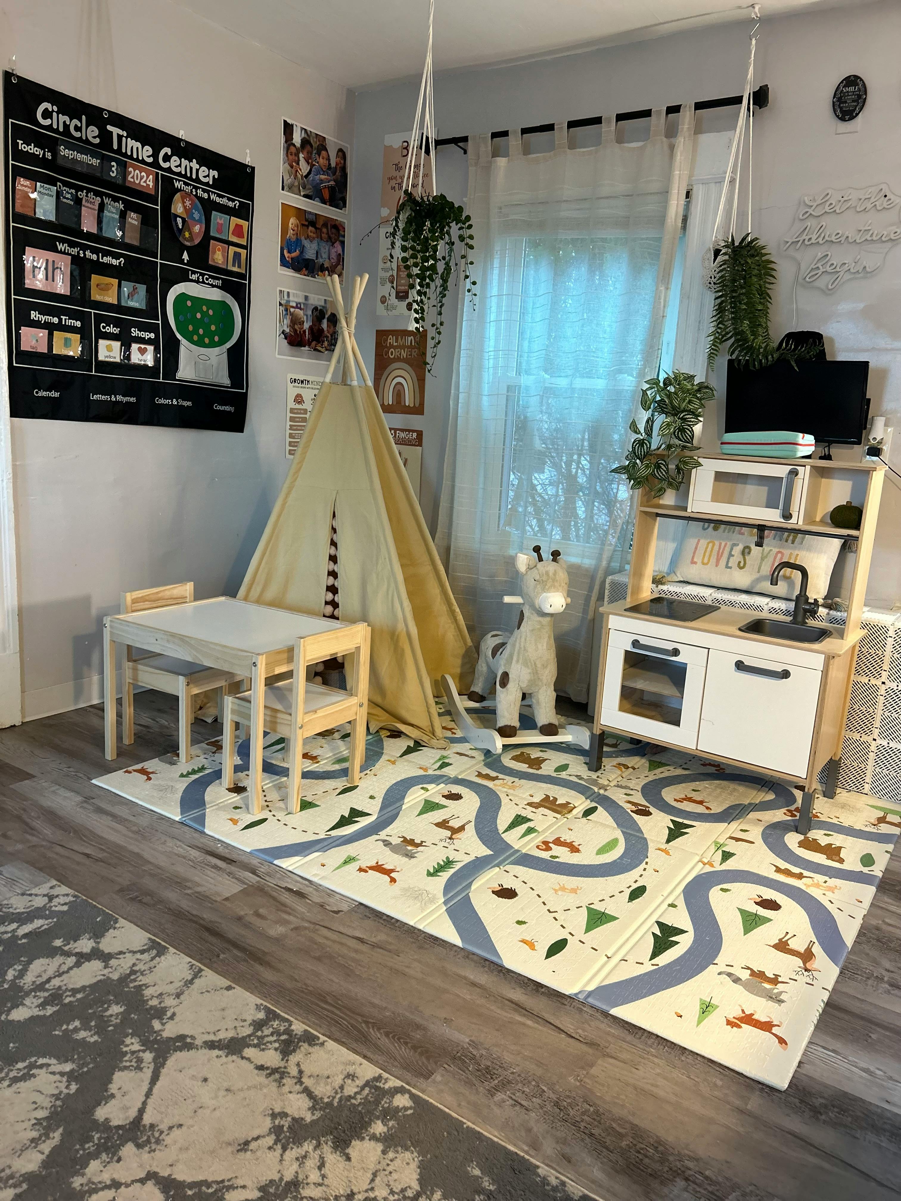 Playroom with a teepee, small table and chairs, and a toy kitchen