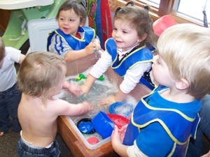 Children playing in water with toys