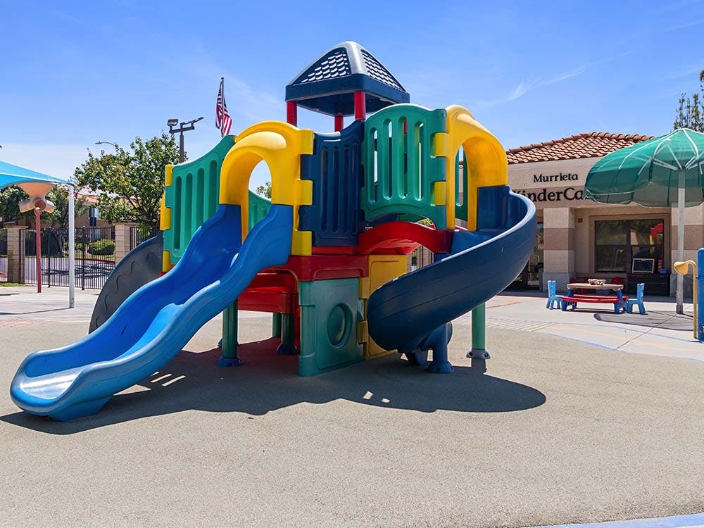 Colorful playground structure with slides and climbing areas outside