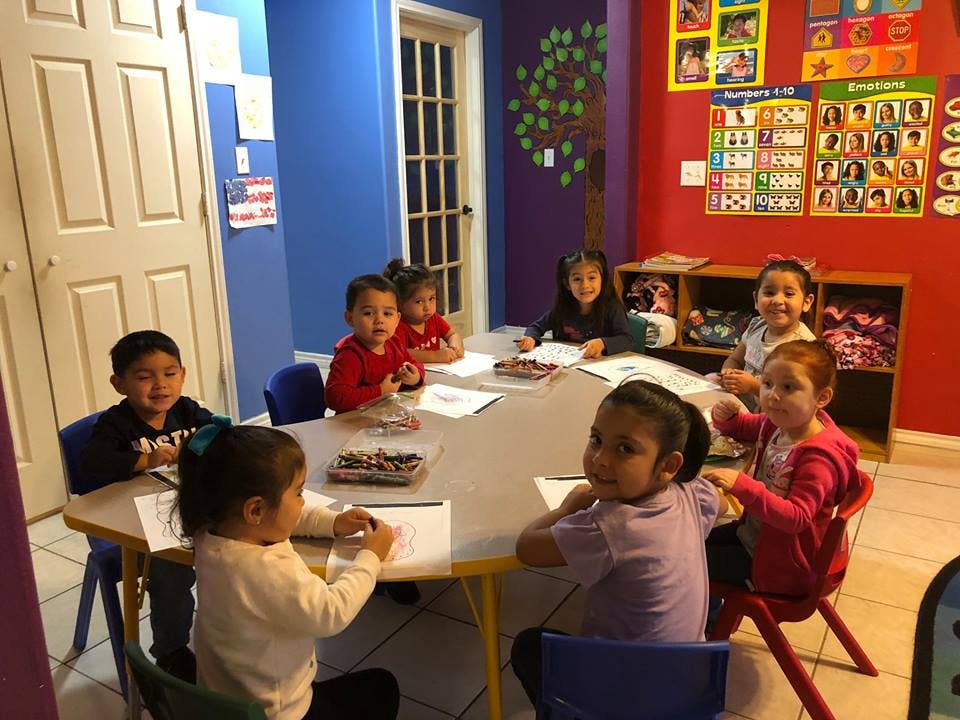 Children sitting around a table in a classroom
