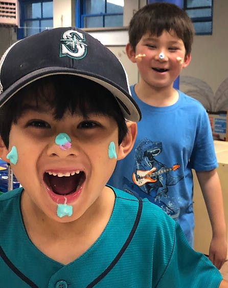 Two children with playdough on their faces