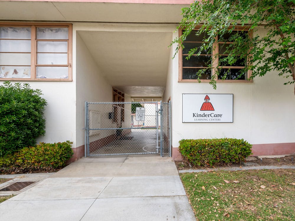 KinderCare Learning Centers sign on a building with a gate
