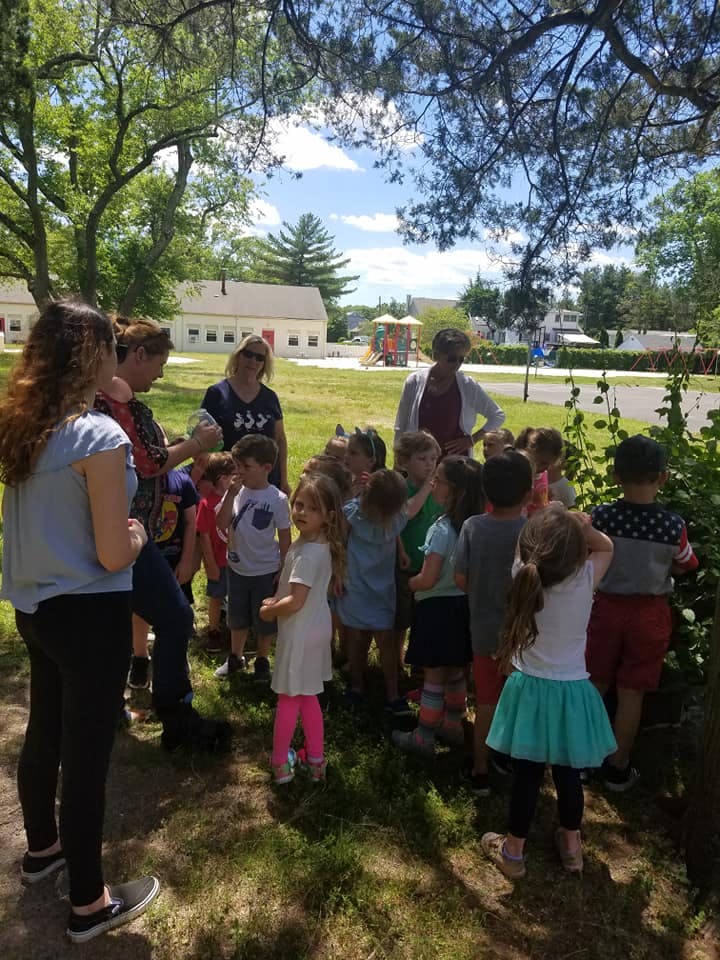 Adults and children gathered outdoors