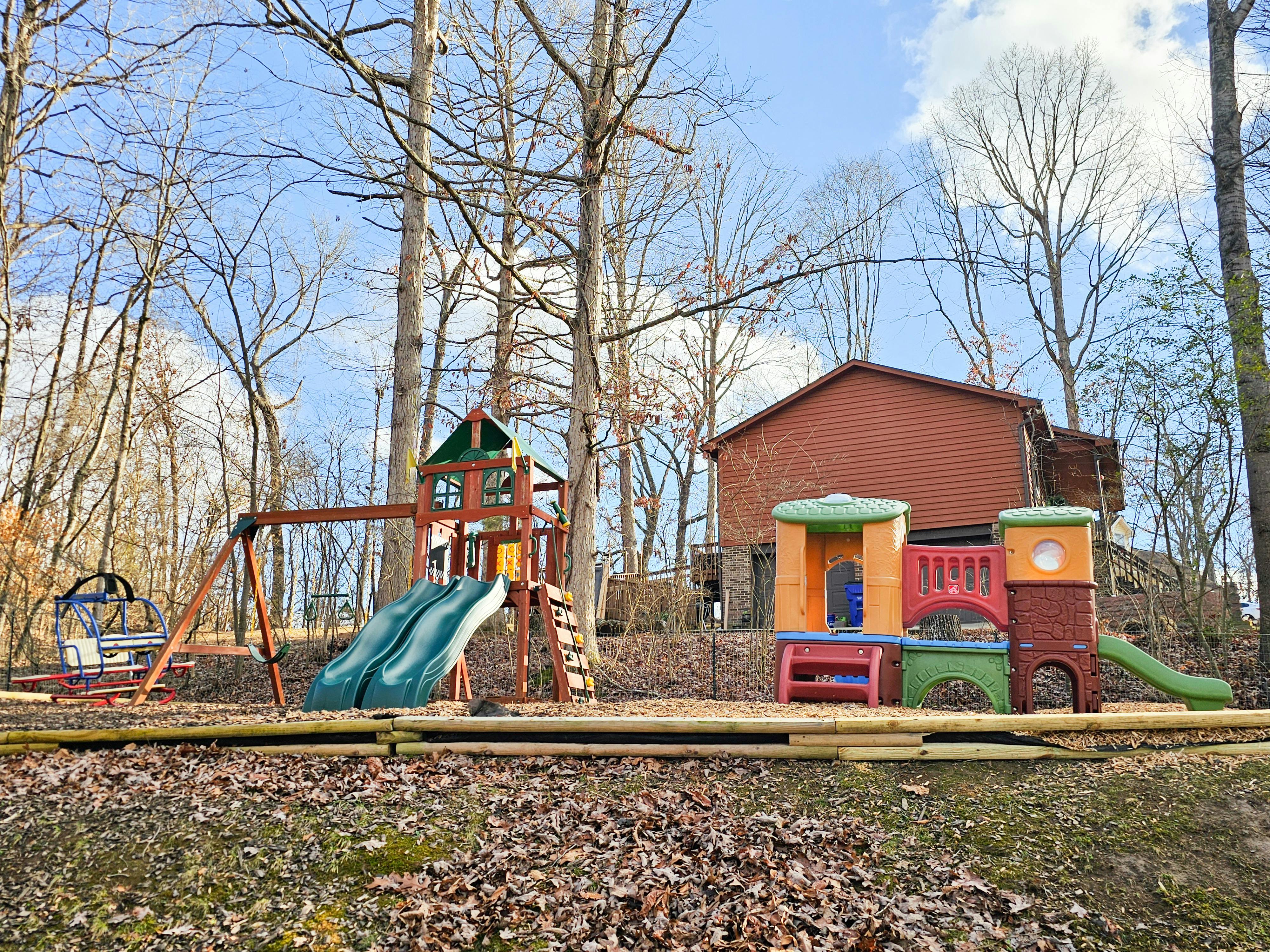 Outdoor playground with swings, slides, and play structures