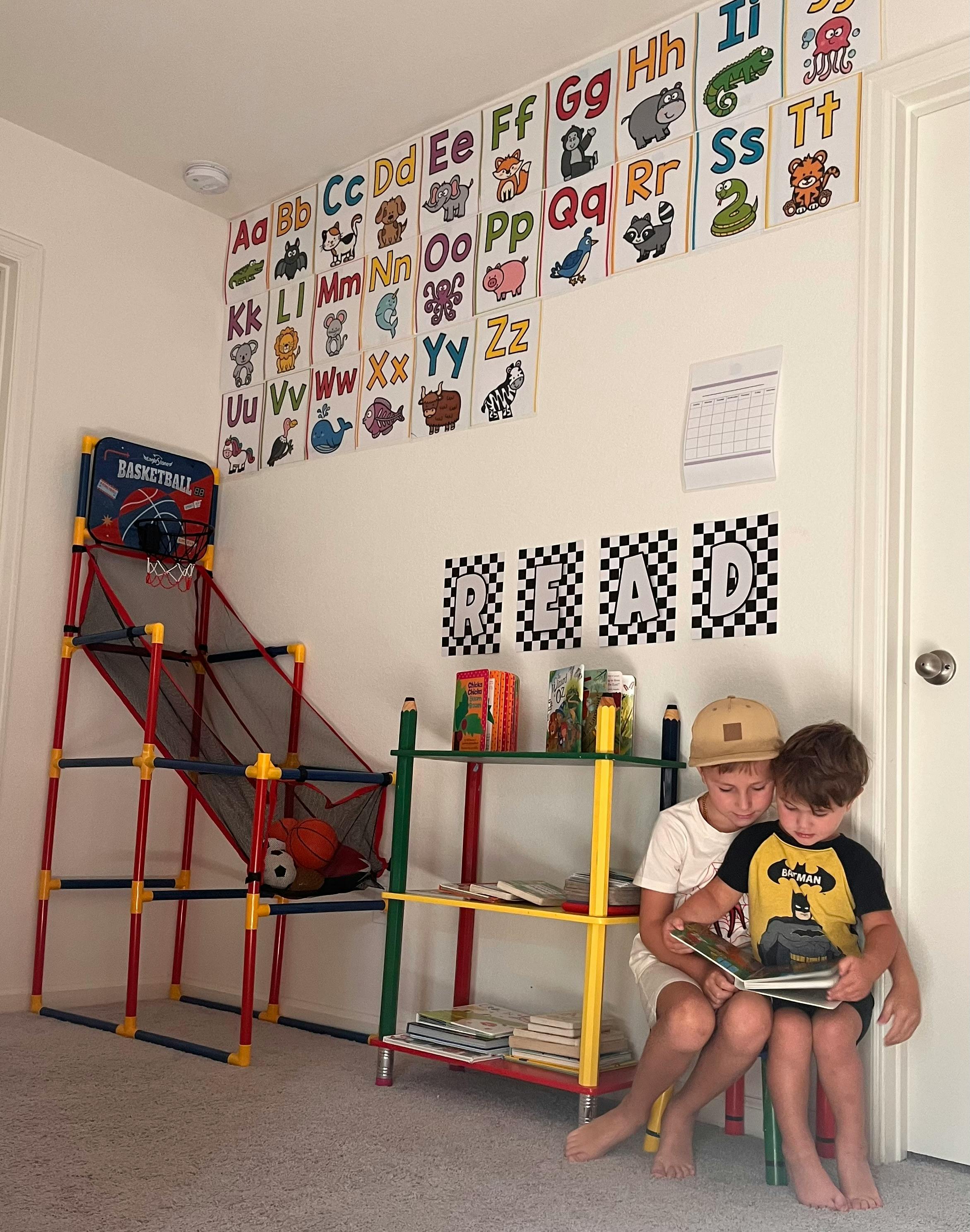 Two children sitting and reading a book together