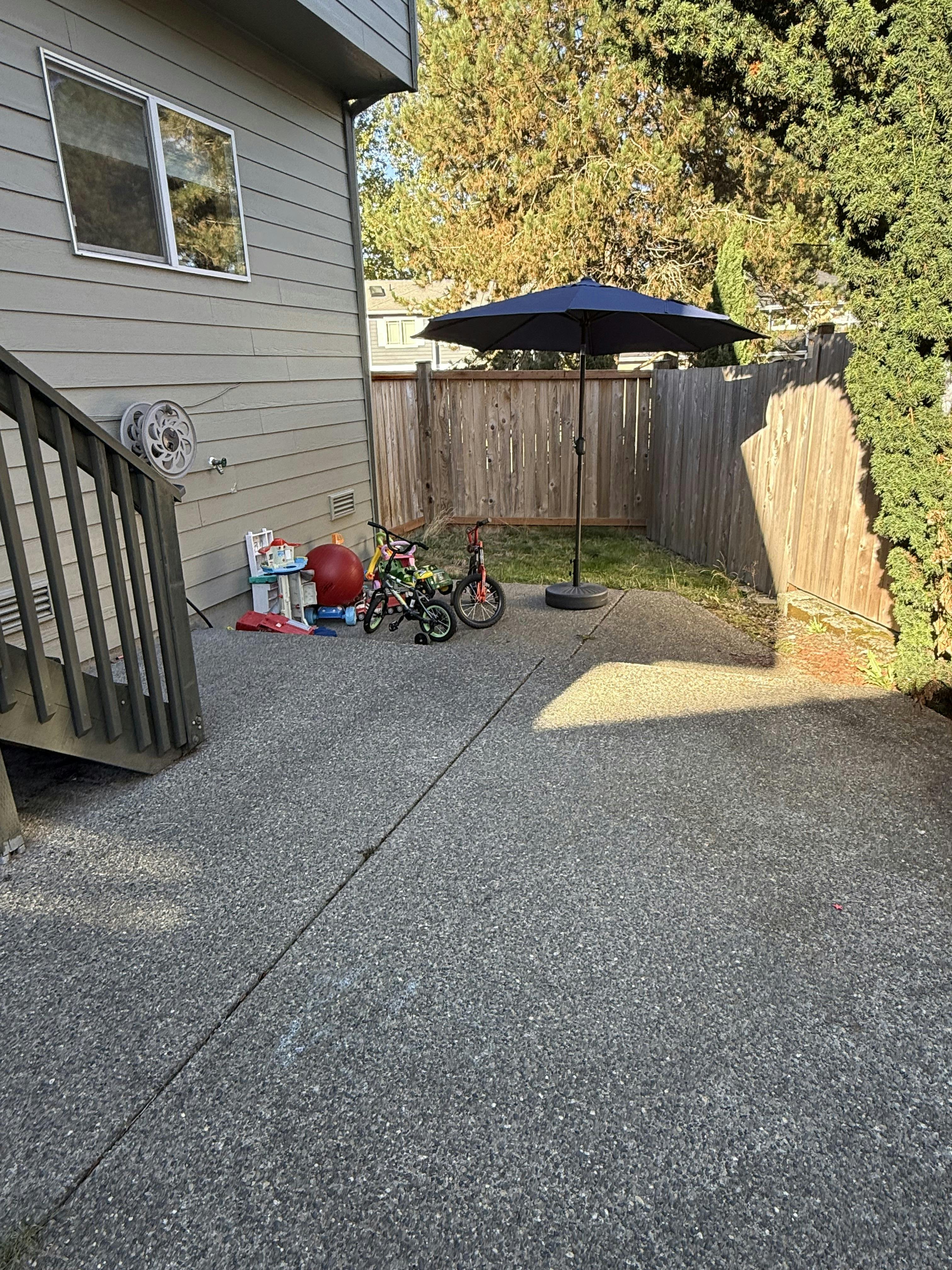 Children's toys and bicycles on a residential backyard patio