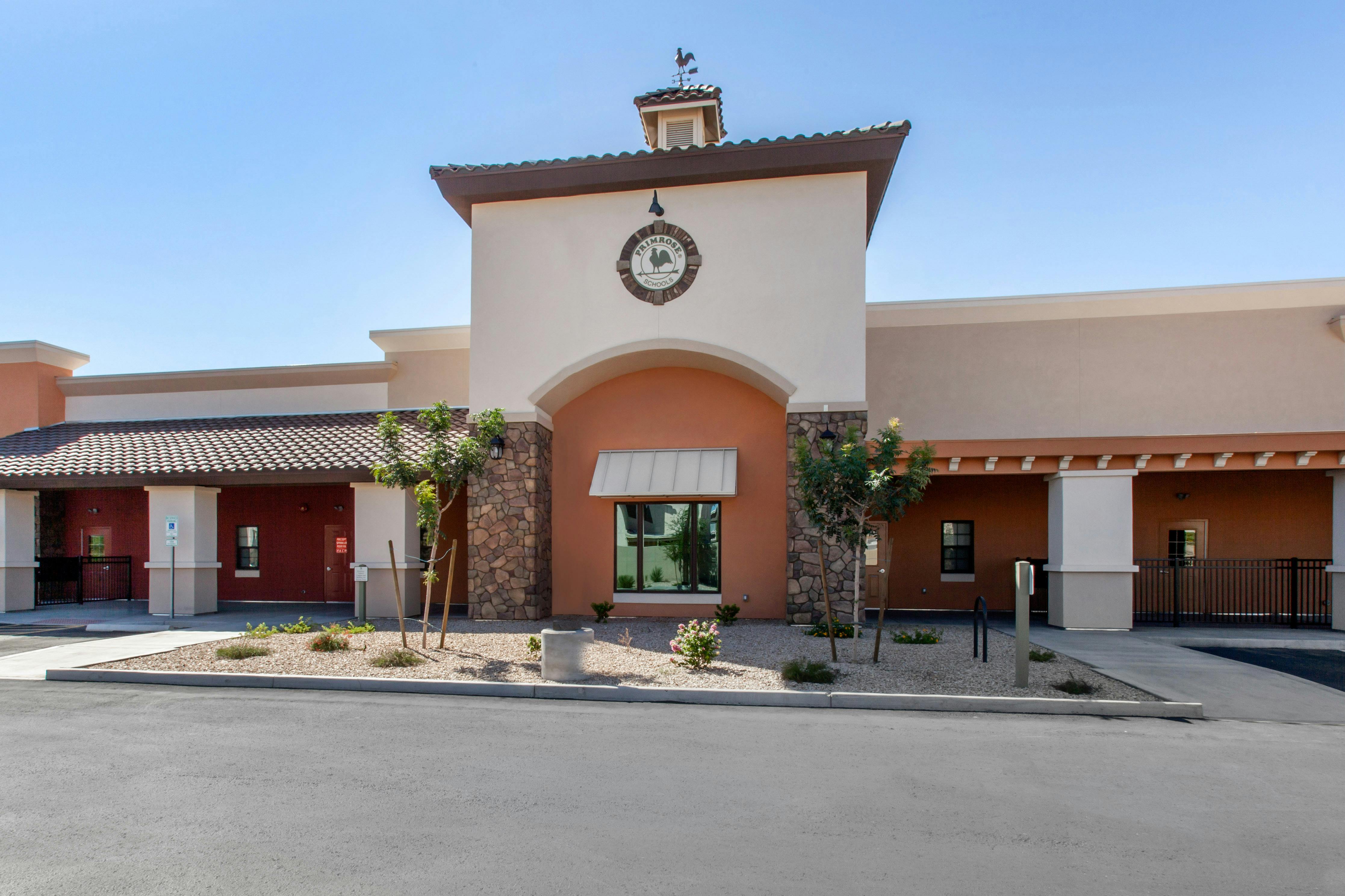 Exterior of the Primrose Schools building, a cream and peach structure with stone accents