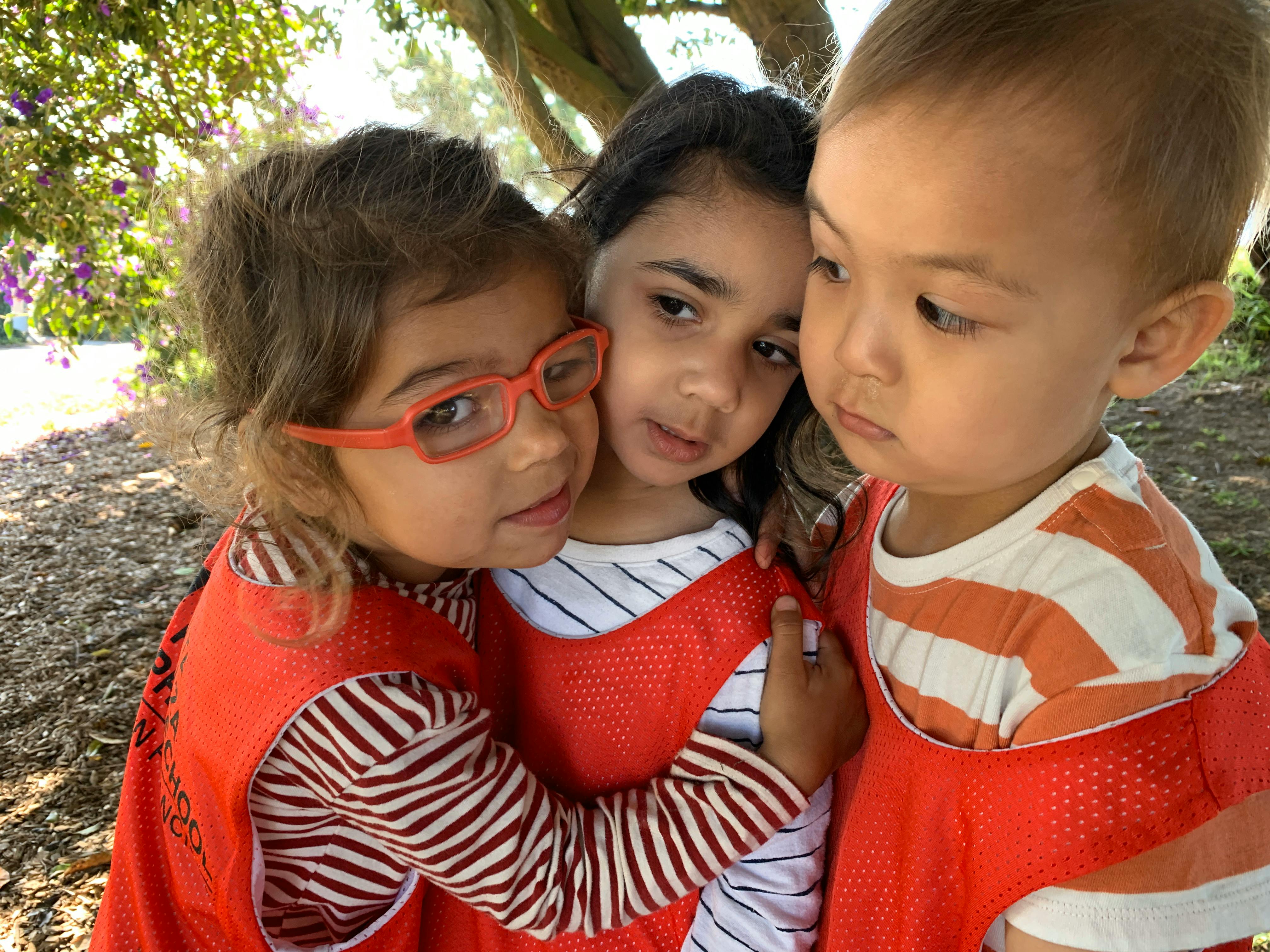 Three children in red vests