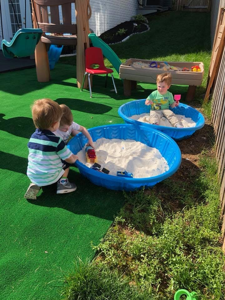 Children playing in sandboxes outdoors