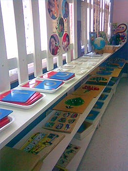 Classroom shelves with learning materials and a globe