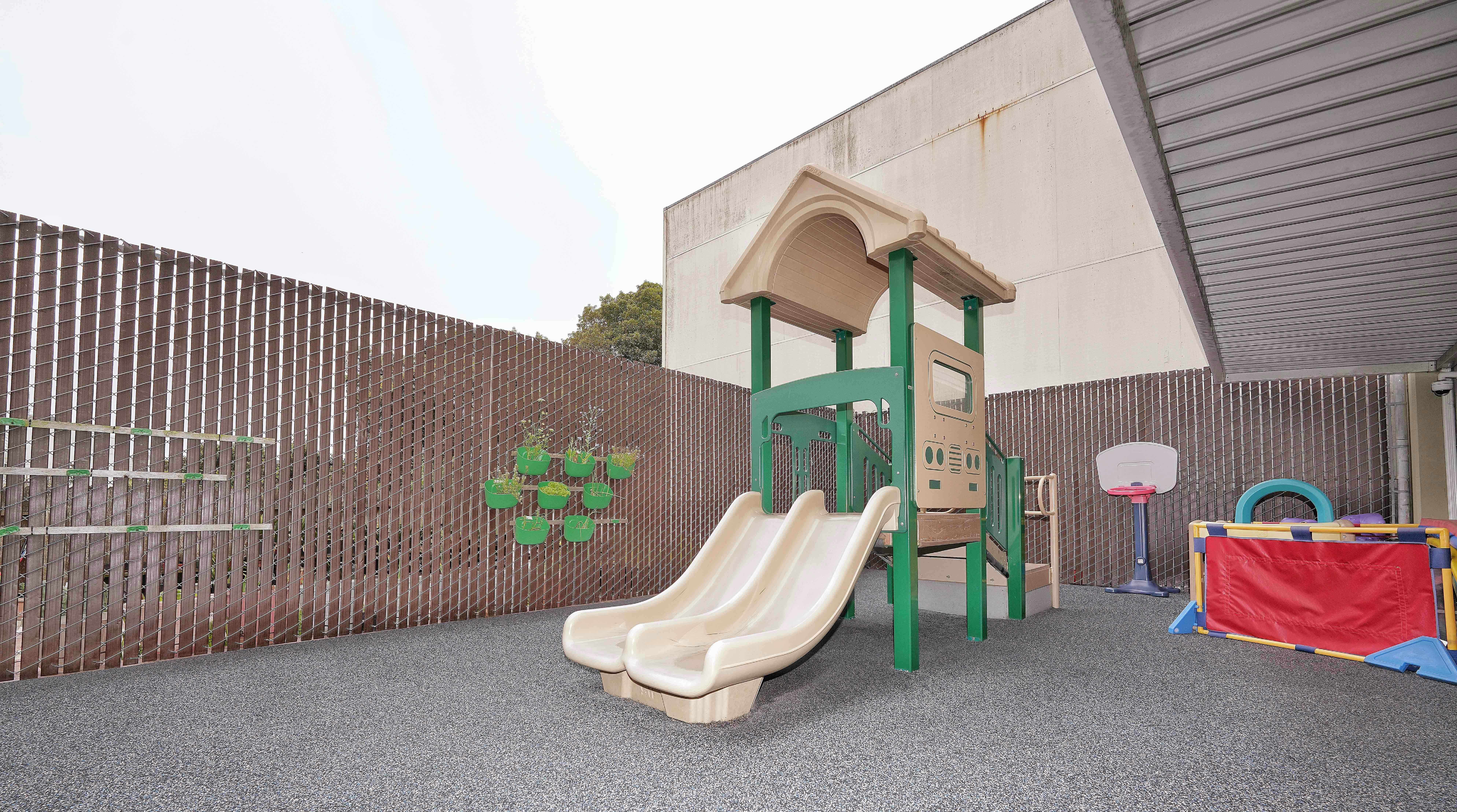 Playground equipment with double slides on a soft surface