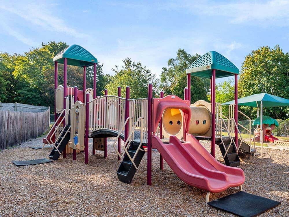 Colorful empty playground with slides and steps on a sunny day