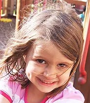 Child smiling with hair blowing