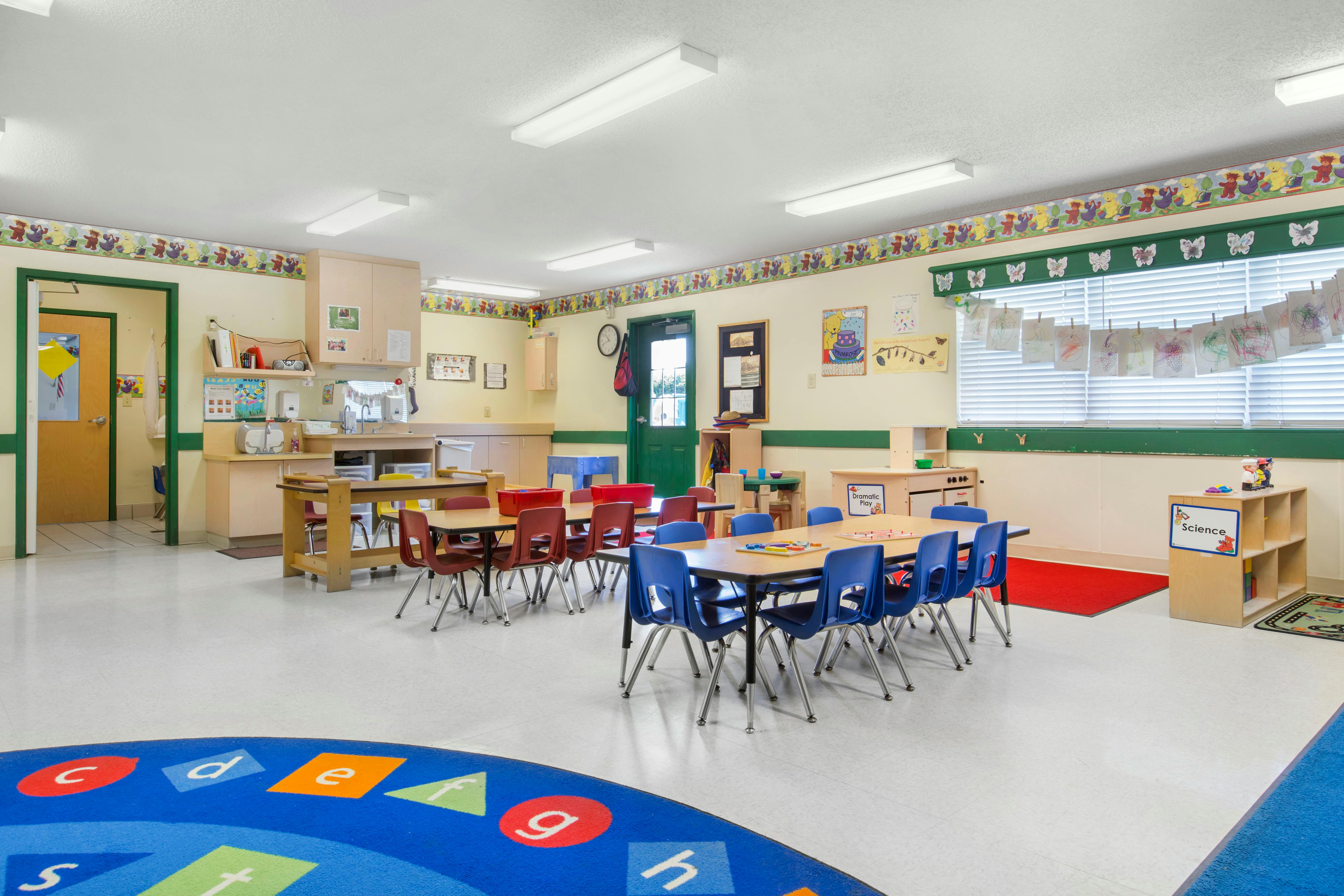 Classroom with tables, chairs, and colorful decorations