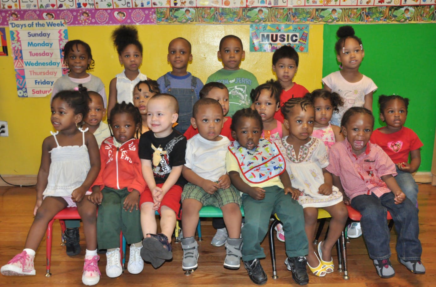 Group of children posing for a photo in a classroom