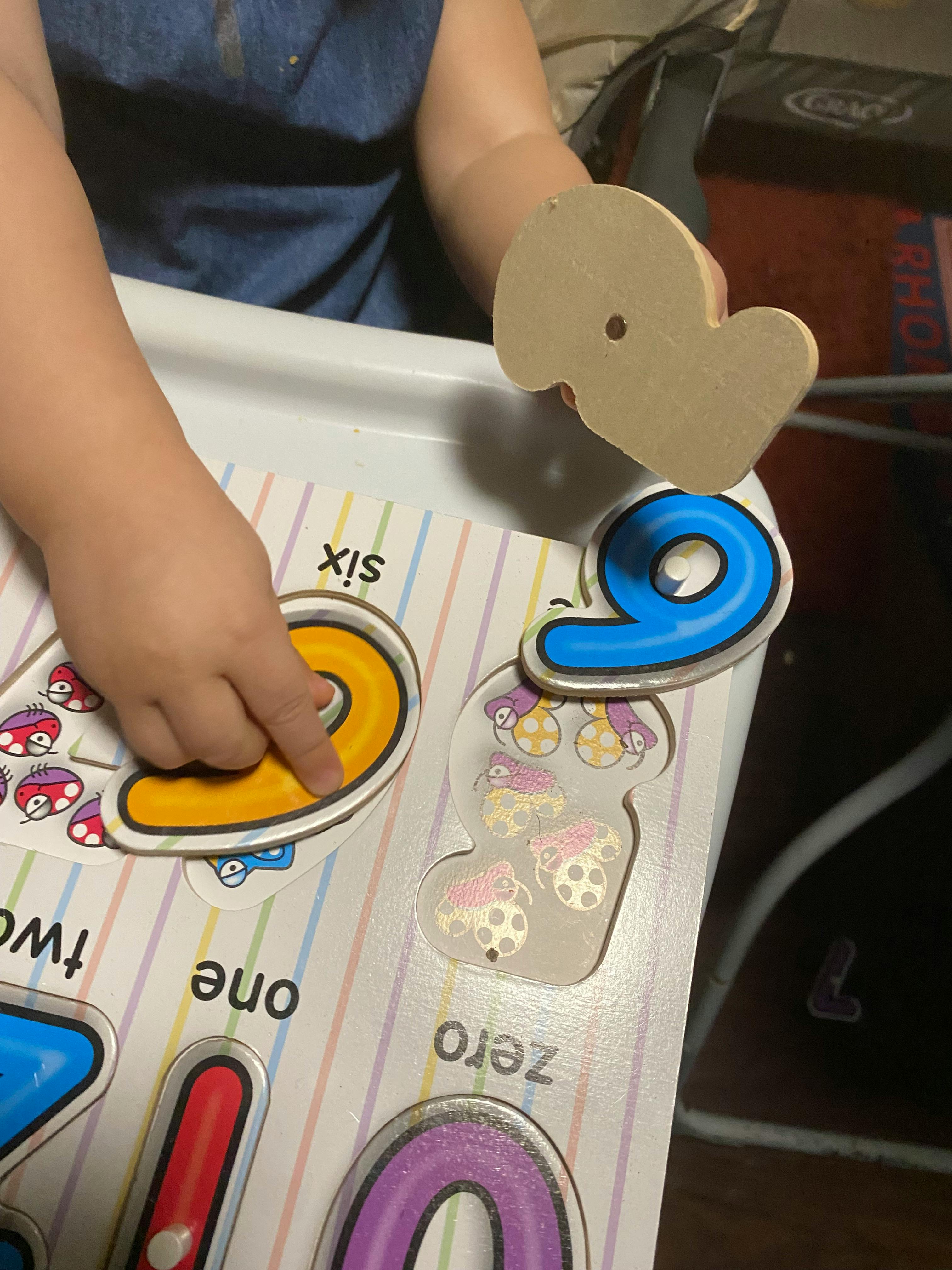 Child's hands playing with a number puzzle