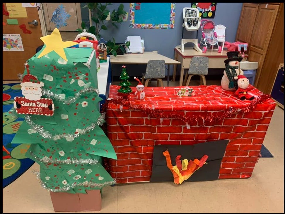 Christmas tree and fireplace decorations in a classroom