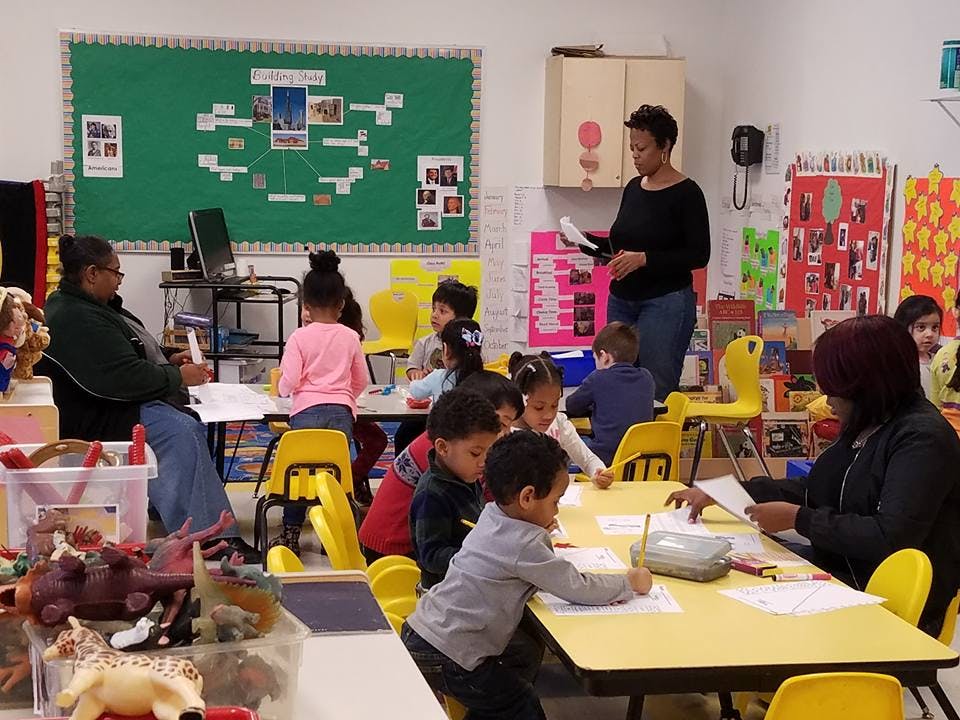 Adults and children in a classroom