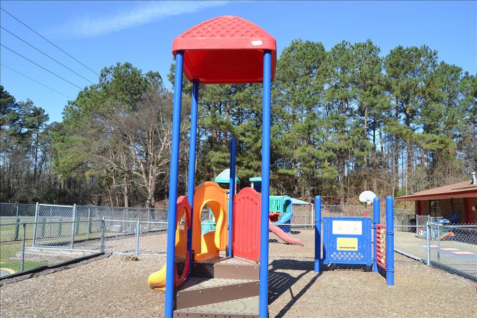 Colorful empty playground with slides and steps on wood chips