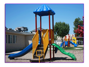Playground with a blue and yellow play structure and slides