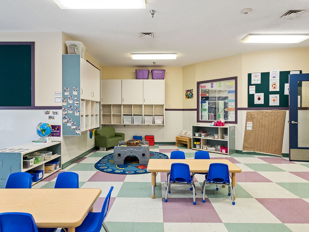 Empty classroom with small tables and chairs